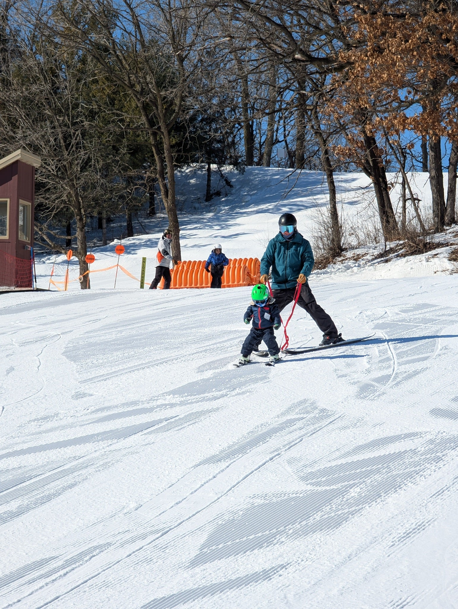 Parent and child skiing with Snap Two Ski tethers