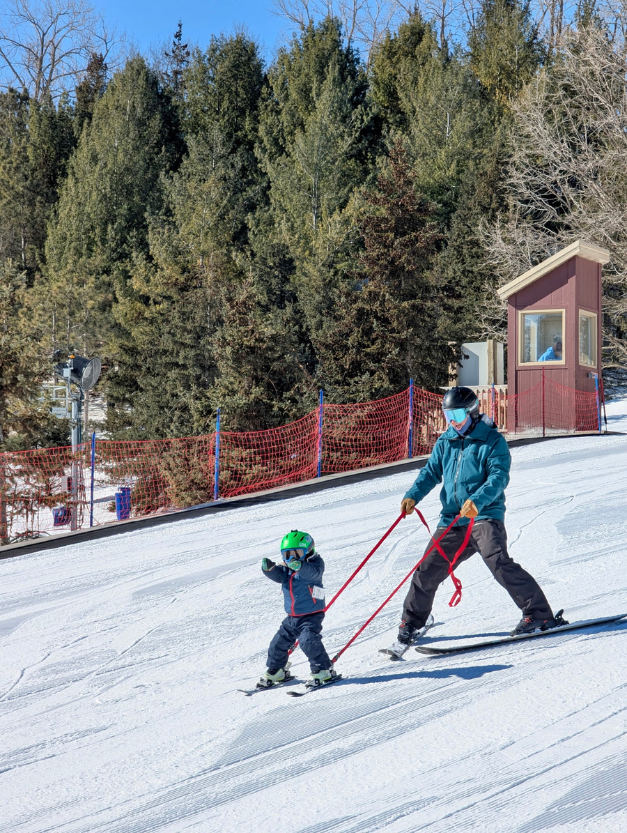 Parent and child skiing with the Snap Two Ski tether